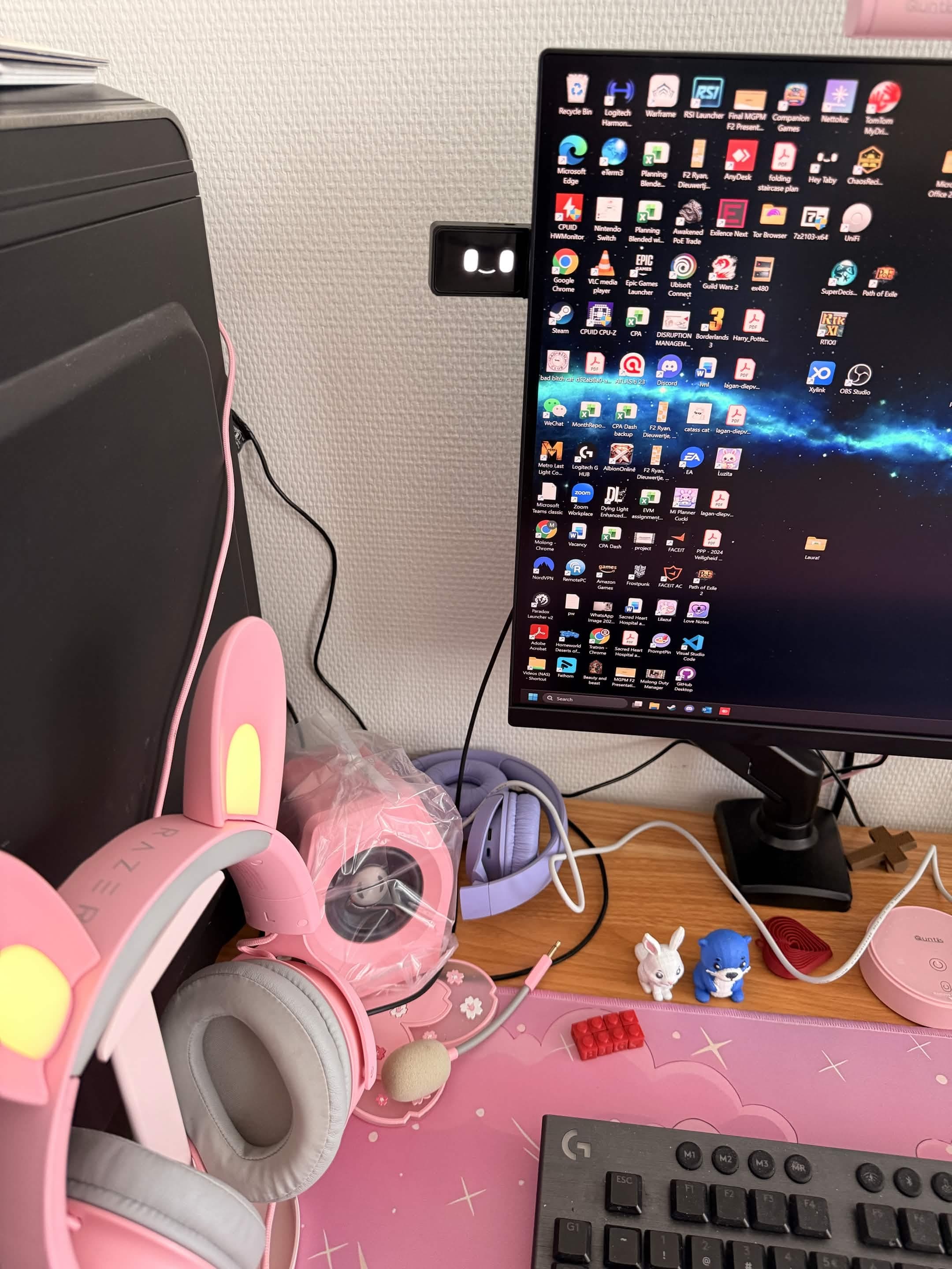 Laura's desk setup with Taby attached beside a monitor.