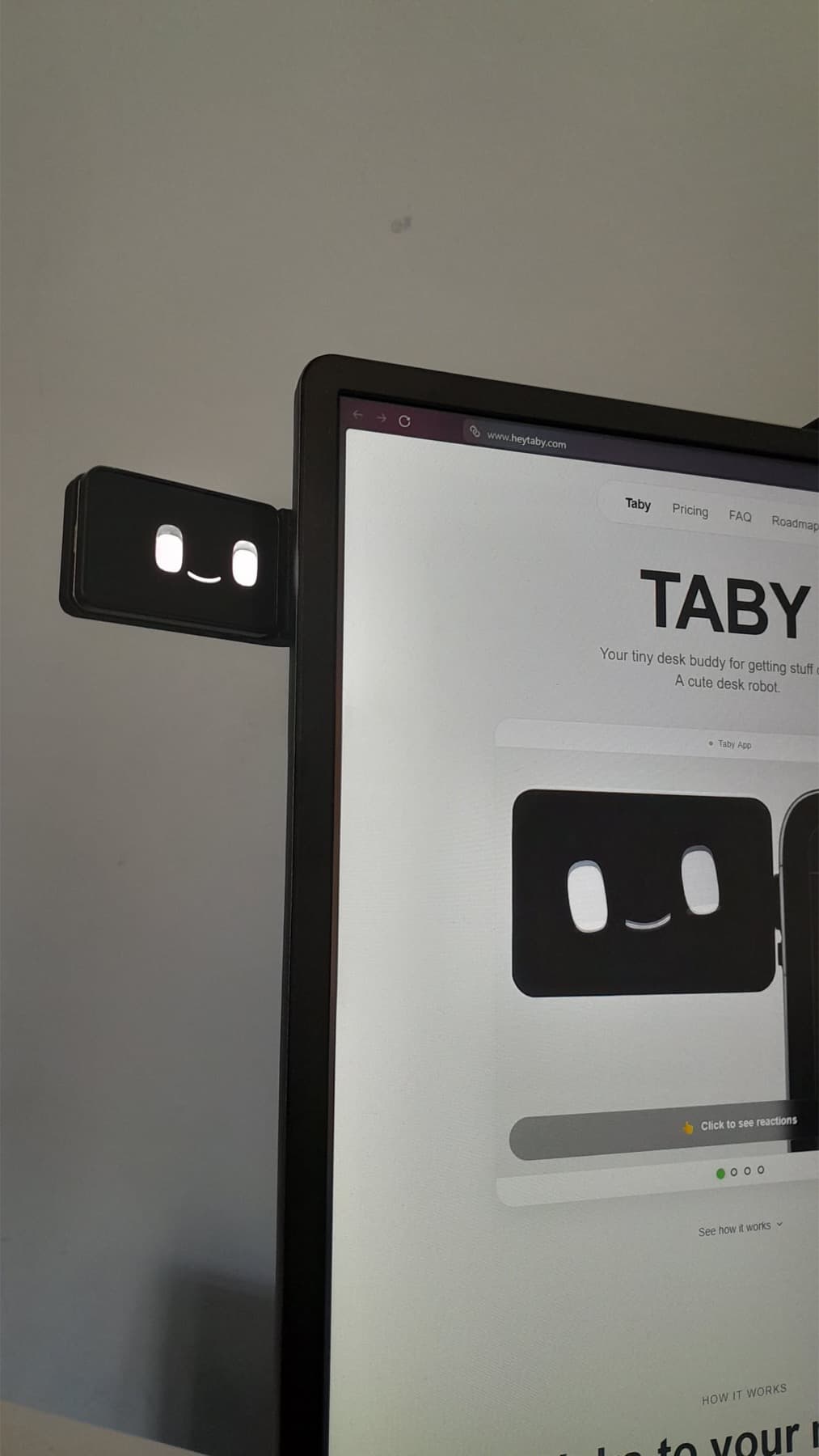 Taby mounted beside a browser window showing the Taby site.