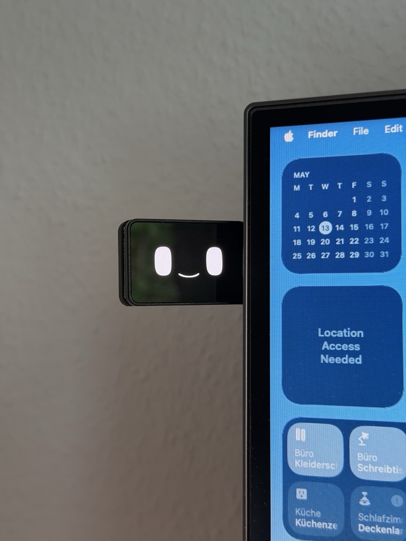 Taby mounted next to a calendar and desktop widgets.
