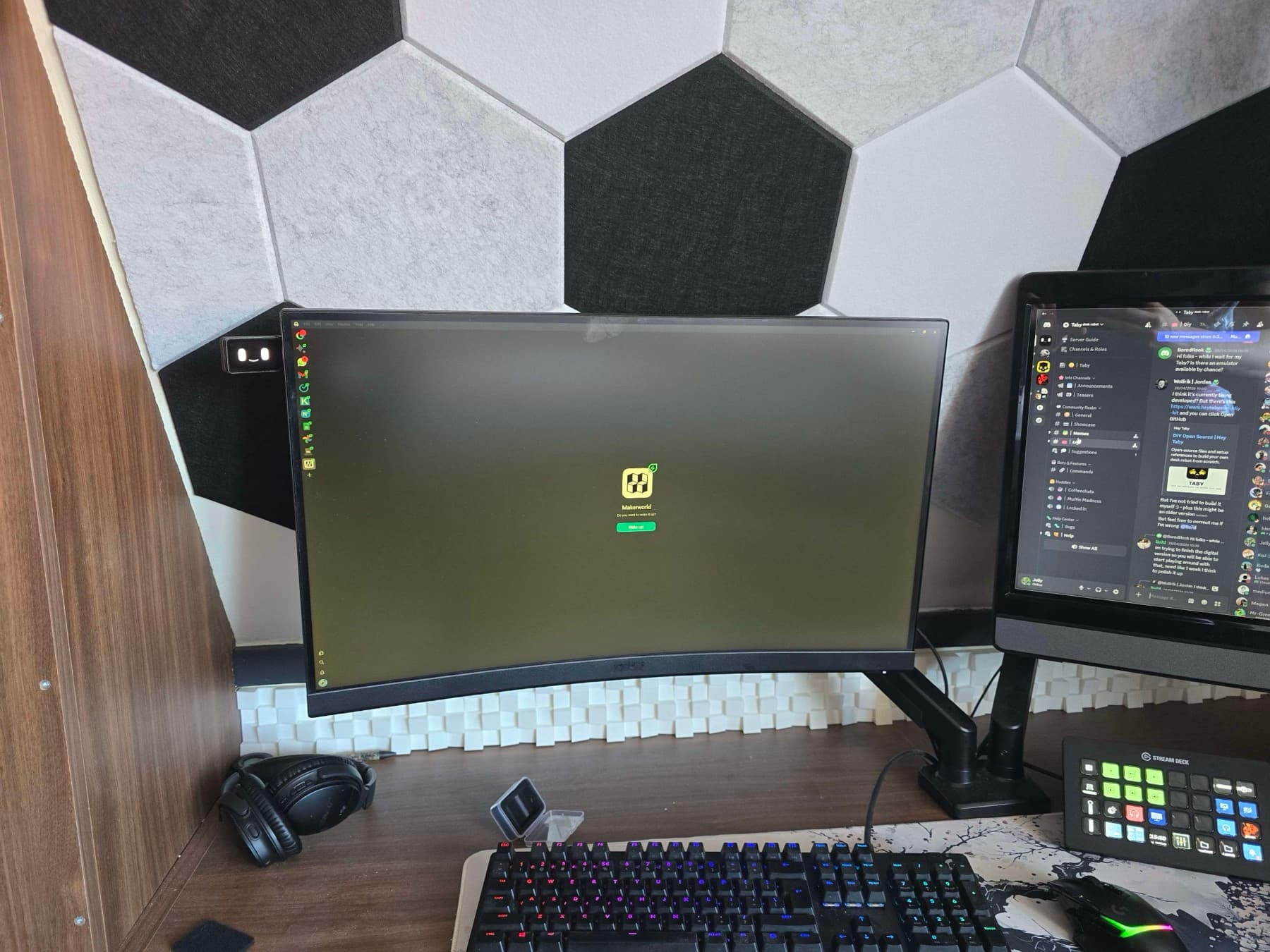 A wide desk setup with Taby mounted near a monitor.